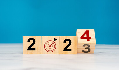 Wooden cubes with the letters 2023 change to 2024 on a table