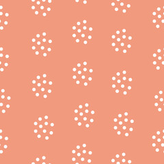 Naklejka na ściany i meble Abstract seamless pattern in peach color with white polka dots. Simple vector background in a flat style