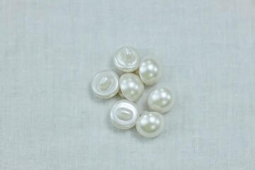 A set of white buttons. The concept of hobbies and crafts.