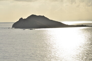 Caribic sun mirroring Water from above Mountains horizon