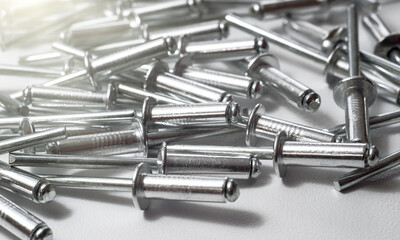 Aluminum tightening rivets close-up. Stainless steel rivets on white isolate