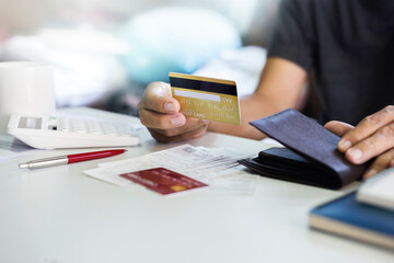 Stressed asian man calculating credit card bills payment, monthly expenses, taxes, bank account balance and , Income is not enough, no money in pocket for expenses
