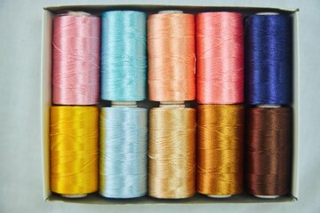 Close - up of coils of threads of different colors and shades for sewing, embroidery and creativity. The concept of Hobbies and crafts.