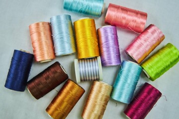 Close - up of coils of threads of different colors and shades for sewing, embroidery and creativity. The concept of Hobbies and crafts.