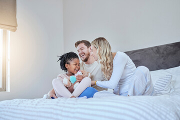 Interracial, adoption family and bed with smile, happiness and bonding together with kid, home and...