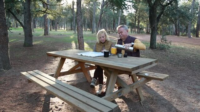 Senior couple planning route while serving coffee