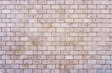 Stone decorative masonry wall background. Bricks made of natural stone surface backdrop. Design, decor, copy space