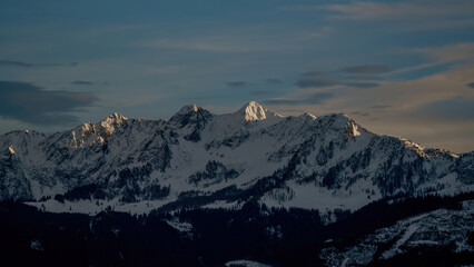 beautiful morning with view of the snow capped alps in the golden sunlight