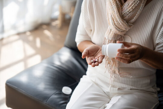 Close Up Mature Woman Taking Out Pills From Bottle, Supplements Or Antibiotic, Older Female Preparing To Take Emergency Medicine, Chronic Disease, Healthcare And Treatment Concept