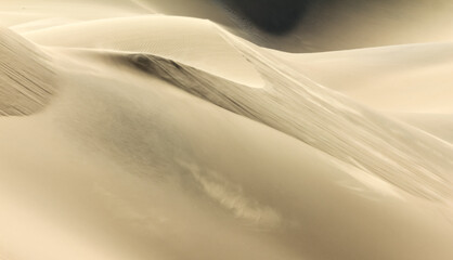 Fototapeta na wymiar Shifting sand dune contrasts. Desert or beach sand textured background.