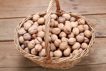 Basket with walnuts on the wooden floor
