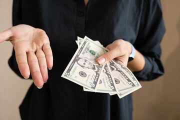 girl holding dollars in her hands, 20 dollars