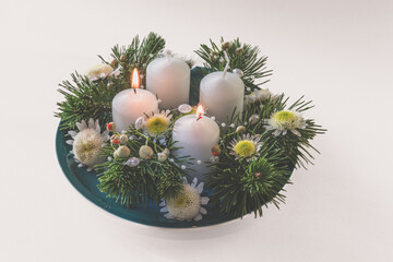 2 advent candles burning on round wreath