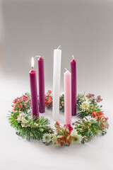 traditional christian religious advent wreath with 5 candles, one candle burning