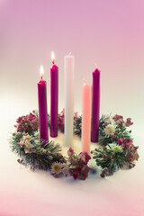 traditional christian religious advent wreath with 5 candles, two candles burning