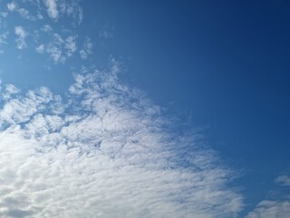 Naklejka na ściany i meble Winter sky with soft white clouds, bright blue sky, beautiful.