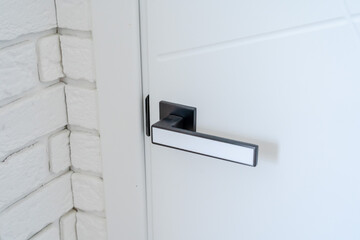Close up photo of a white interior door handle