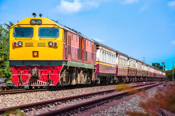 Fototapeta premium Passenger train by diesel locomotive on the railway.