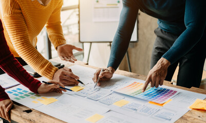 Close up view of UI developer team brainstorming on their project with laptop, smartphone and digital tablet. Creative digital development agency