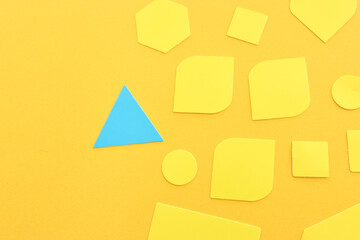 Concept of unique thinking. Paper shapes of the same color versus a different one