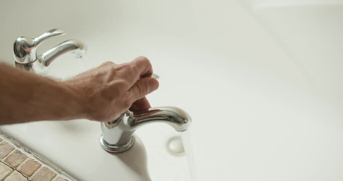 water flowing from the tap in the bathroom | 4k footage 12 bit
