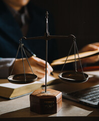 Business and lawyers discussing contract papers with brass scale on desk in office. Law, legal services, advice, justice and law concept