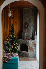 Decorating Christmas tree. Christmas concept. Christmas tree next to the fireplace. 
