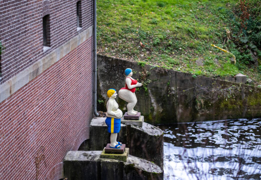 small dams and mills. Two floating human statues by the lake. Parks and gardens in Europe. Vreden in Germany..