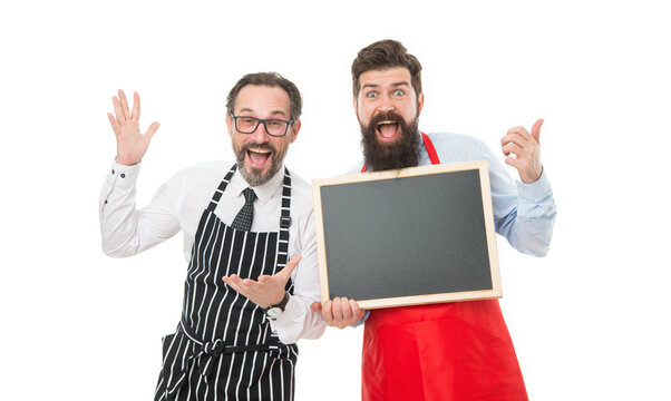 Men bearded informing. Men bearded bartender in apron hold blank chalkboard. Bartender with blackboard advertisement. Hipster bartender show blackboard copy space. Join us. Hiring restaurant staff
