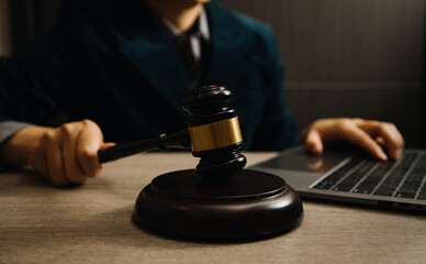 Business and lawyers discussing contract papers with brass scale on desk in office. Law, legal services, advice, justice and law concept picture with film grain effect