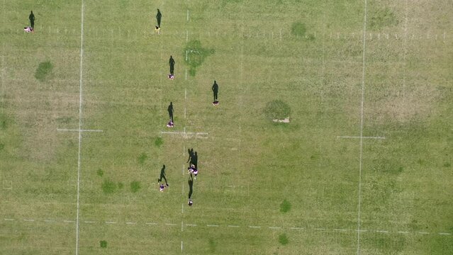 Amazing aerial view of a Ragbi field and players.