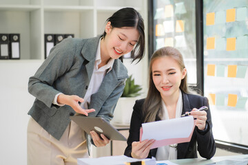 Portrait of Asian young female working on laptop at office