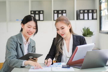 Portrait of Asian young female working on laptop at office