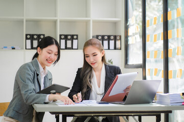 Portrait of Asian young female working on laptop at office