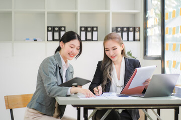 Portrait of Asian young female working on laptop at office