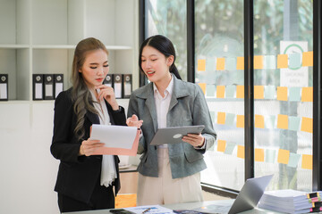 Portrait of Asian young female working on laptop at office