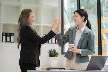 Portrait of Asian young female working on laptop at office