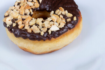 Sweet Donuts with Chocolate Frosting and Nuts. Close-up photography.