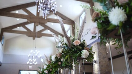 Flowers are displayed on a long table at their Texas Hill Country wedding. Mainly for the reception, they match the other wedding themed decor.