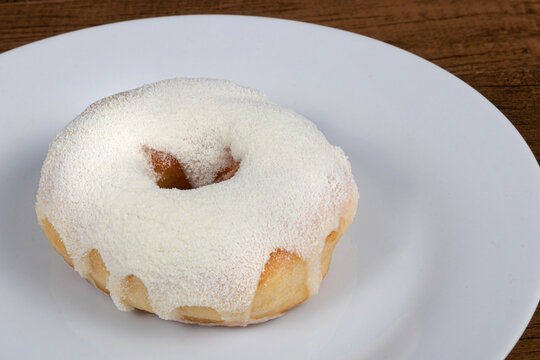 Sweet donuts with cream topping and powdered milk.