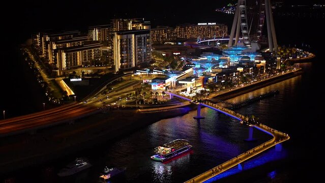 Timelapse of the Night Dubai Marina area with the image of the bridge and Ferris wheel