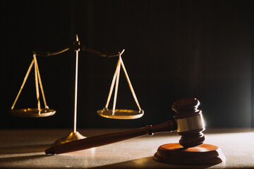 Business and lawyers discussing contract papers with brass scale on desk in office. Law, legal...