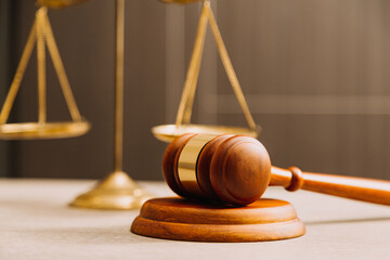 Business and lawyers discussing contract papers with brass scale on desk in office. Law, legal services, advice, justice and law concept picture with film grain effect