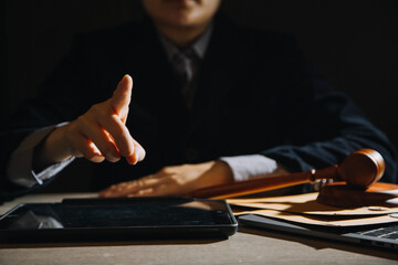Business and lawyers discussing contract papers with brass scale on desk in office. Law, legal services, advice, justice and law concept picture with film grain effect