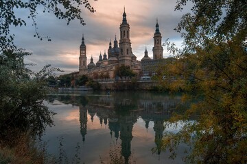 Autumn photography at sunset from the Basilica of Our Lady of the Pilar in Zaragoza, next to the Ebro river and the Stone Bridge, Aragon, Spain.
