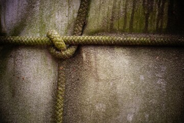 Macro shot of tight knotted ropes over the fabric