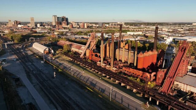 Blast furnace factory and museum in Birmingham Alabama USA. Aerial pullback reveals AL skyline in USA.