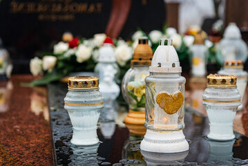 All Saints' Day and burning candles and flowers on the graves.Candles on graves symbolize the...