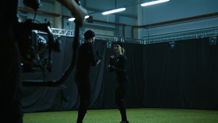 BTS of game industry - Actors in motion capture suits performing some fight moves as a game...