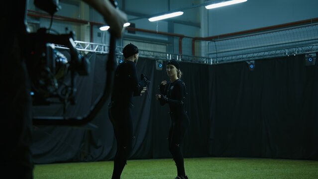 BTS of game industry - Actors in motion capture suits performing some fight moves as a game characters. Motion capture is an unparalleled method for making animated characters move more realistically